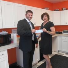 116_353_90_Rockland_Trust_Grant_Check_Pres._-_David_Felton_and_Roz_Rubin001.JPG20150602155203 David Felton, Vice President and Senior Business Banking Officer at Rockland Trust, presents a check for $10,000 to Roslynn Rubin, GWArc CEO, in GWArc's updated kitchen at 56 Chestnut Street, Waltham. The Rockland Trust Charitable Foundation granted the funds to support recently completed upgrades to GWArc's kitchen and a program room to improve safety and increase space for program activities. While GWArc continues to seek larger community space, these critical updates allow the agency to maintain quality programs and services.